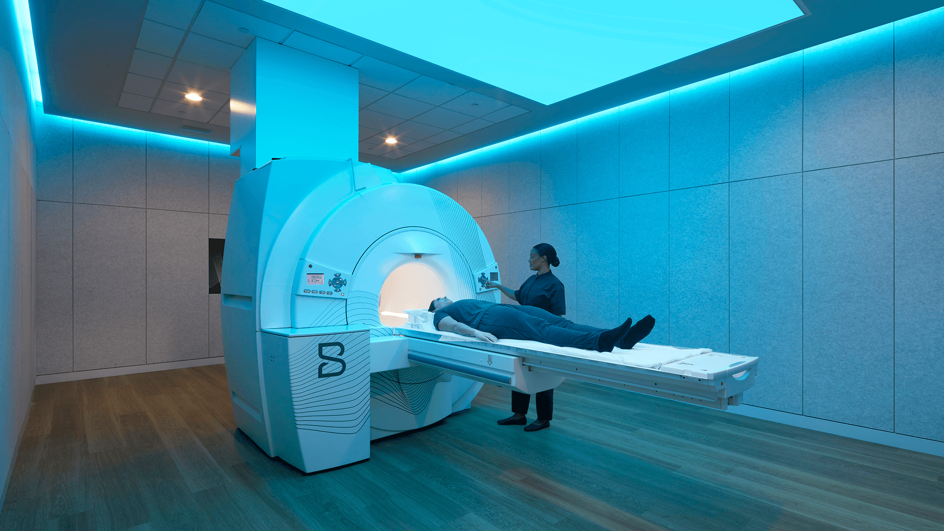Biograph clinic MRI suite bathed in teal light.
